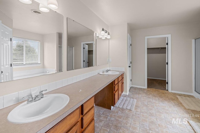 12339 W Foxhaven St, Star, ID 83669 - bathroom with a stall shower, a spacious closet, and double vanity