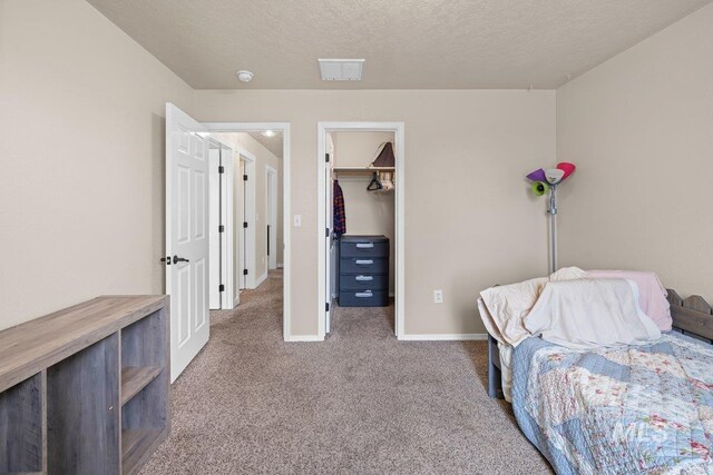 12339 W Foxhaven St, Star, ID 83669 - bedroom featuring carpet, a walk in closet, a textured ceiling, and a closet