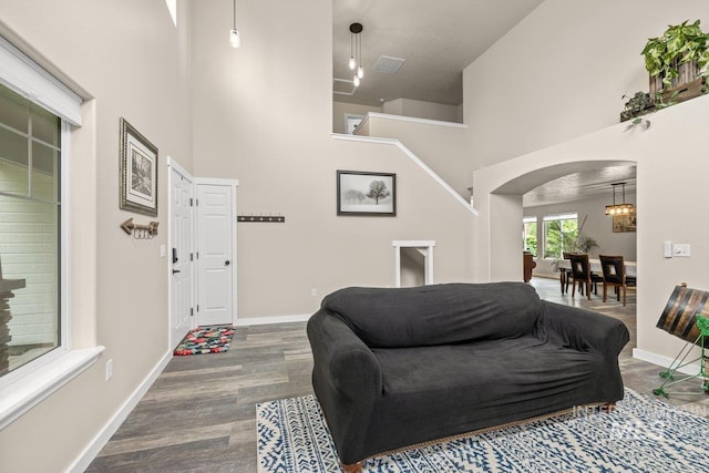 12339 W Foxhaven St, Star, ID 83669 - living room featuring arched walkways, a towering ceiling, and wood finished floors