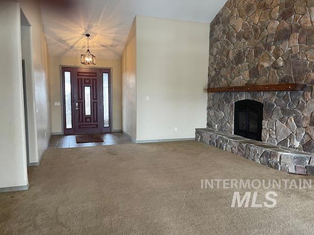 2655 13th St, Clarkston, WA 99403 - entrance foyer featuring carpet floors, baseboards, a chandelier, and a stone fireplace