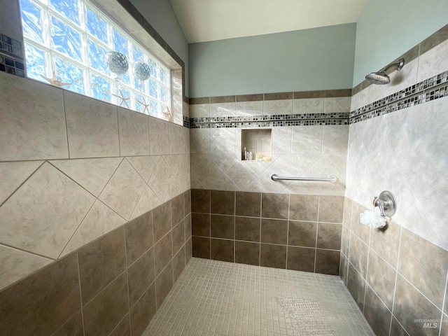 bathroom with a tile shower