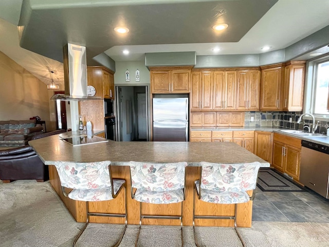 kitchen with island range hood, sink, a kitchen bar, decorative backsplash, and black appliances