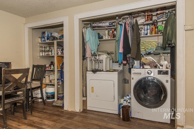 washroom with a textured ceiling, laundry area, wood finished floors, and washer and clothes dryer