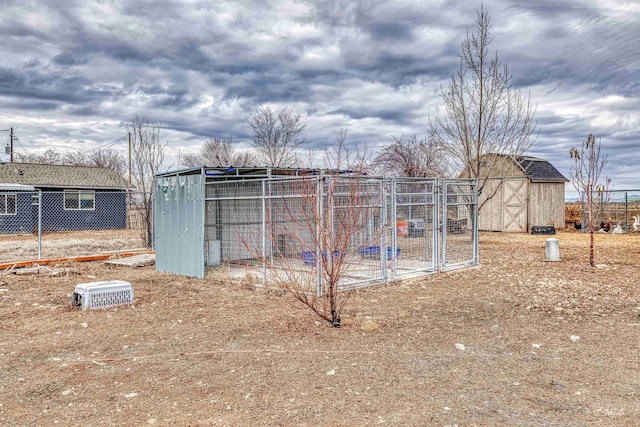 exterior space with fence and an outbuilding