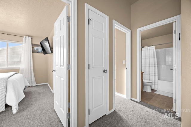 16702 Frisco Ave, Caldwell, ID 83607 - bedroom with carpet floors, baseboards, connected bathroom, and a textured ceiling