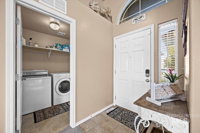 16702 Frisco Ave, Caldwell, ID 83607 - laundry area featuring washer and clothes dryer, tile patterned floors, and baseboards