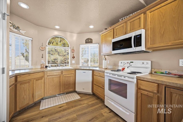 16702 Frisco Ave, Caldwell, ID 83607 - kitchen with white appliances, a sink, dark wood-style flooring, a textured ceiling, and light countertops