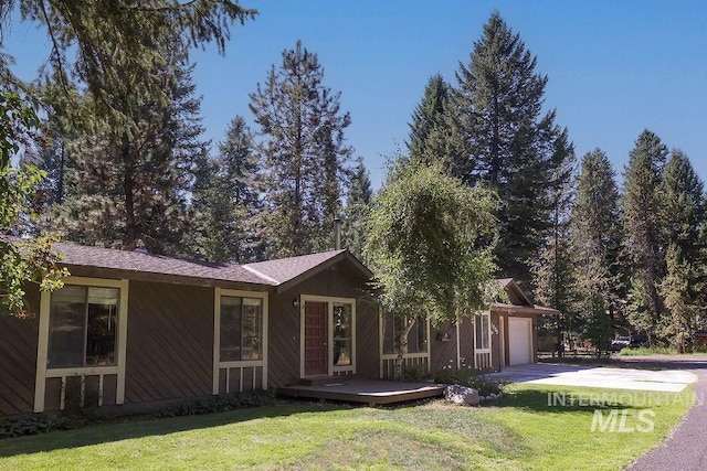 ranch-style house with a deck and a front yard