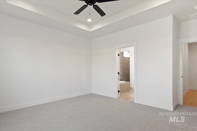 carpeted spare room with ceiling fan