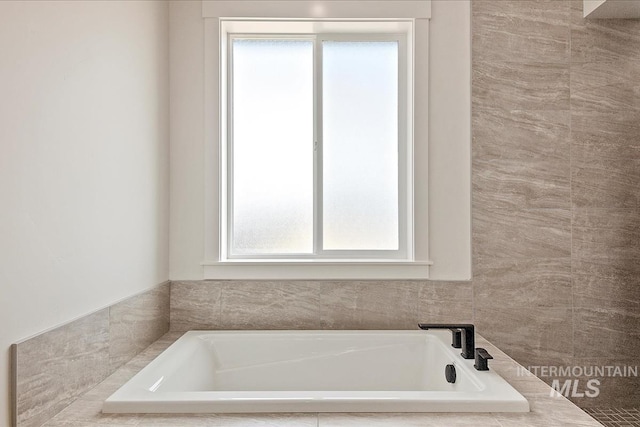 bathroom featuring tiled bath