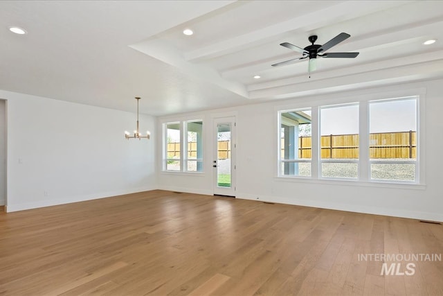 spare room featuring ceiling fan with notable chandelier, beam ceiling, and light hardwood / wood-style flooring