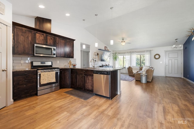 2026 Kelly Dr, Payette, ID 83661 - kitchen featuring stainless steel appliances, open floor plan, a sink, dark brown cabinets, and light wood-style flooring