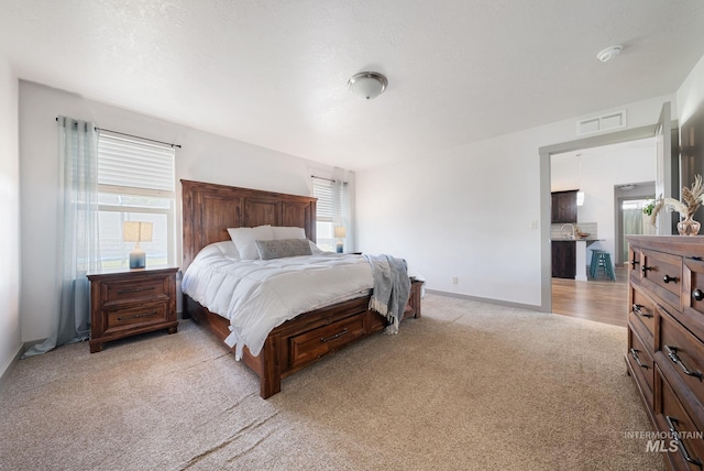 2026 Kelly Dr, Payette, ID 83661 - bedroom featuring light carpet, multiple windows, and baseboards
