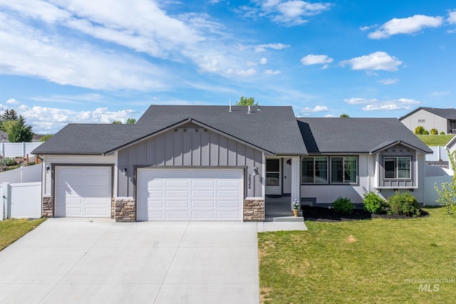 2026 Kelly Dr, Payette, ID 83661 - view of front of home featuring board and batten siding, a garage, roof with shingles, and driveway