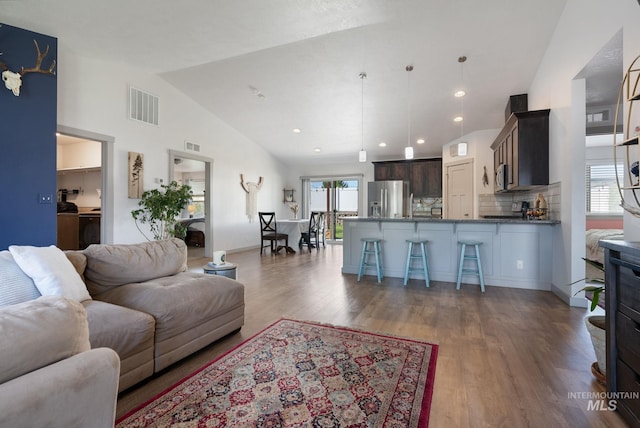2026 Kelly Dr, Payette, ID 83661 - living area with lofted ceiling, wood finished floors, washer / dryer, and recessed lighting
