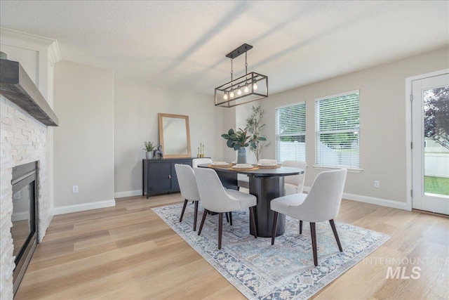 1499 E Sicily St, Meridian, ID 83642 - dining area with light wood-style floors, plenty of natural light, and a stone fireplace