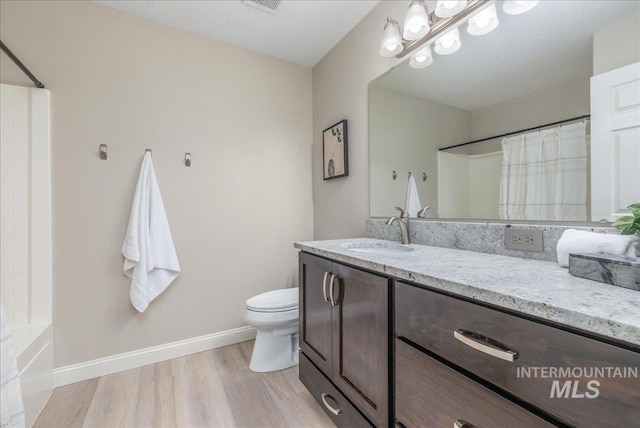 1499 E Sicily St, Meridian, ID 83642 - bathroom featuring wood finished floors, vanity, and shower / bath combo with shower curtain