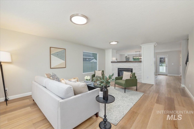 1499 E Sicily St, Meridian, ID 83642 - living room with light wood-style flooring and a stone fireplace