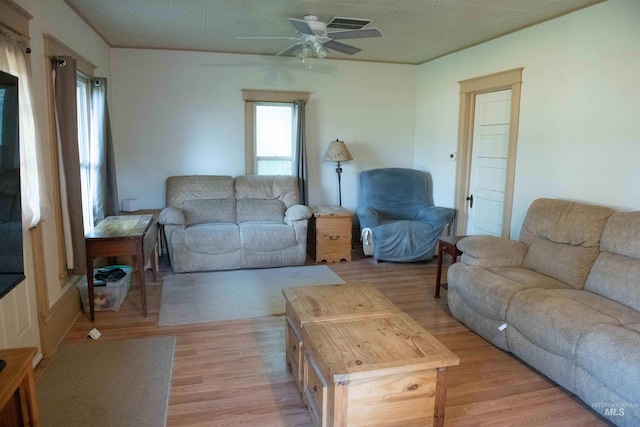 living room with light hardwood / wood-style floors and ceiling fan