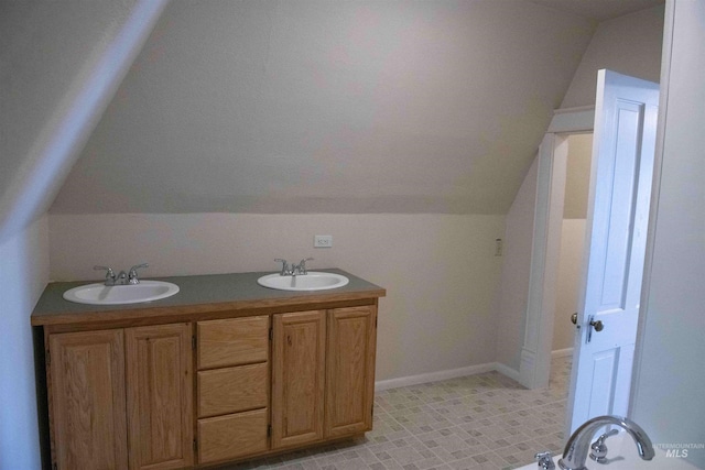 bathroom with vanity and vaulted ceiling