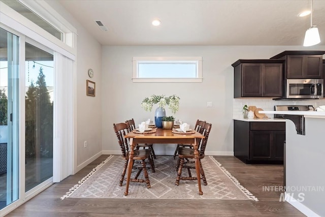 dining space with hardwood / wood-style floors