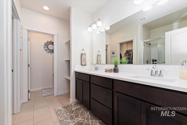 bathroom with tile patterned flooring and vanity