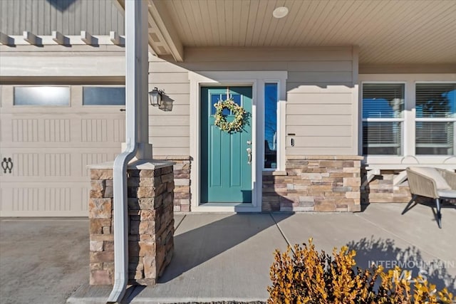 doorway to property with a garage