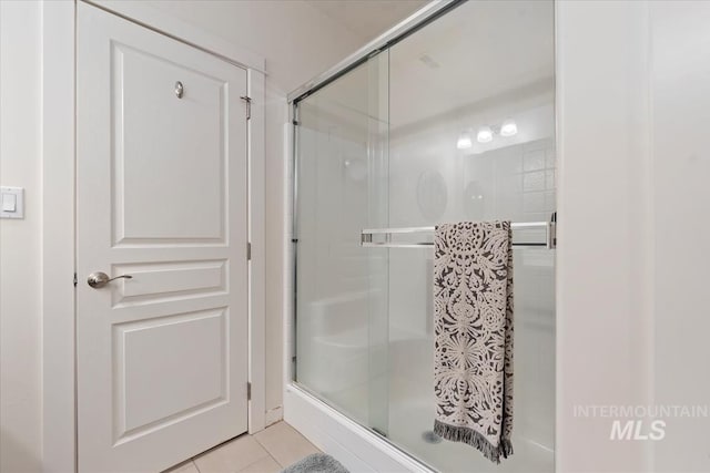 bathroom featuring tile patterned flooring and a shower with door