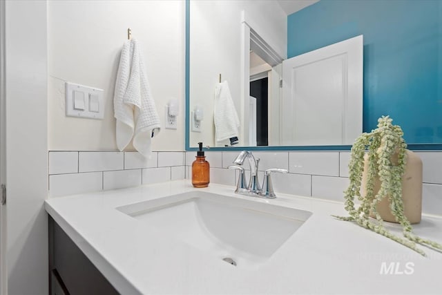 bathroom featuring vanity and backsplash