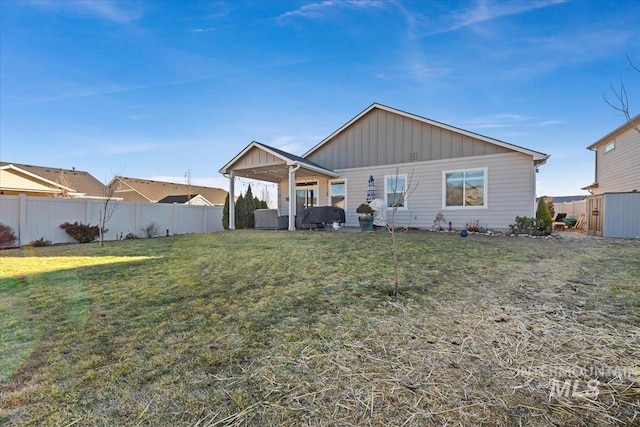 rear view of house with a lawn