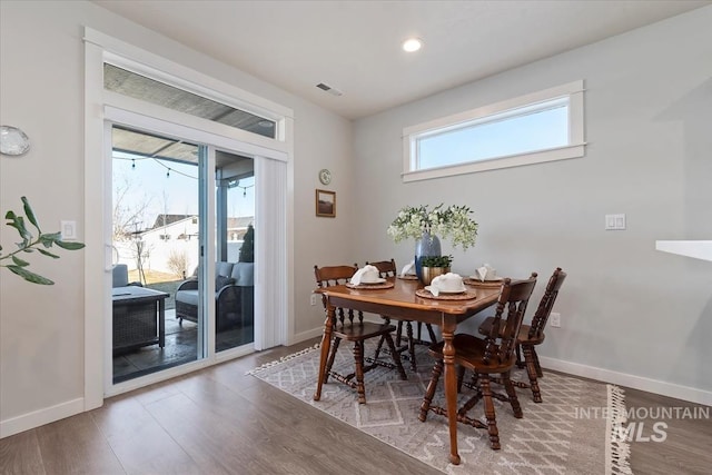 dining space featuring wood-type flooring