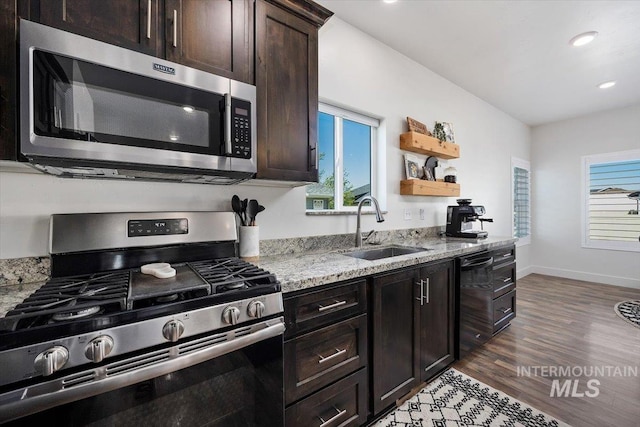 kitchen featuring light stone countertops, stainless steel appliances, dark hardwood / wood-style floors, and sink