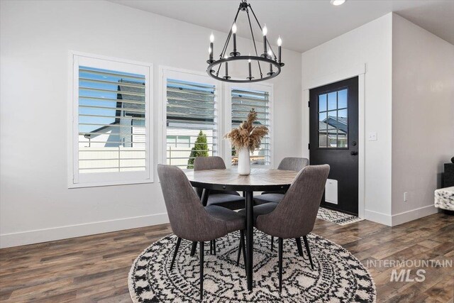 dining area featuring dark wood-type flooring and a chandelier