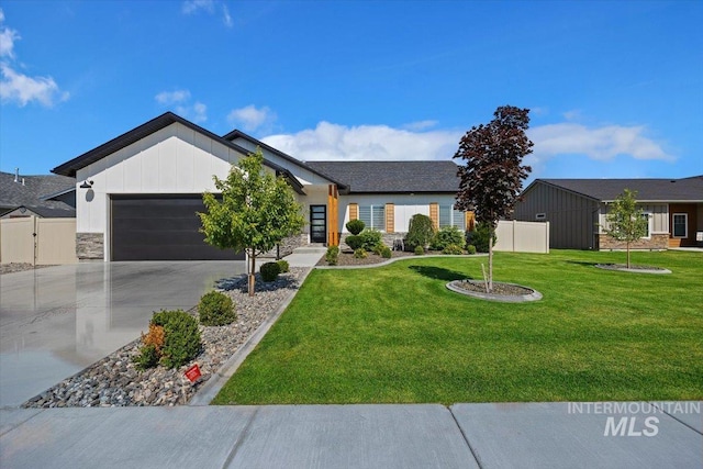 view of front of property featuring a garage and a front lawn