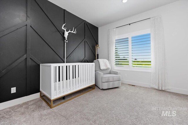 carpeted bedroom with lofted ceiling and a nursery area