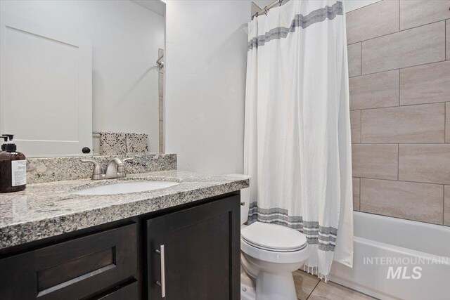 full bathroom featuring vanity, toilet, shower / bath combo with shower curtain, and tile patterned floors