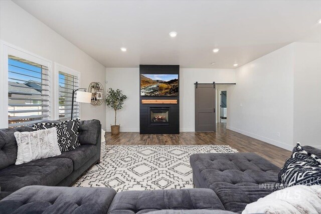 living room featuring wood-type flooring and a barn door