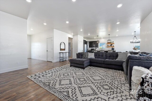 living room featuring hardwood / wood-style flooring and a notable chandelier