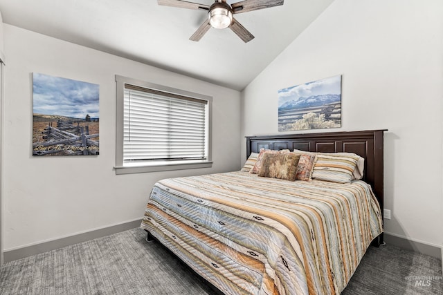 bedroom featuring dark colored carpet, vaulted ceiling, and ceiling fan