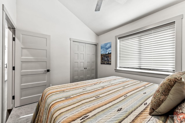 bedroom with light carpet, vaulted ceiling, a closet, and ceiling fan