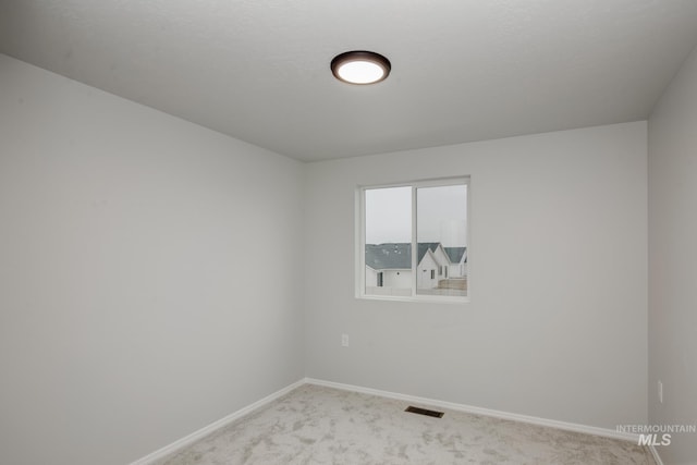 empty room featuring light colored carpet