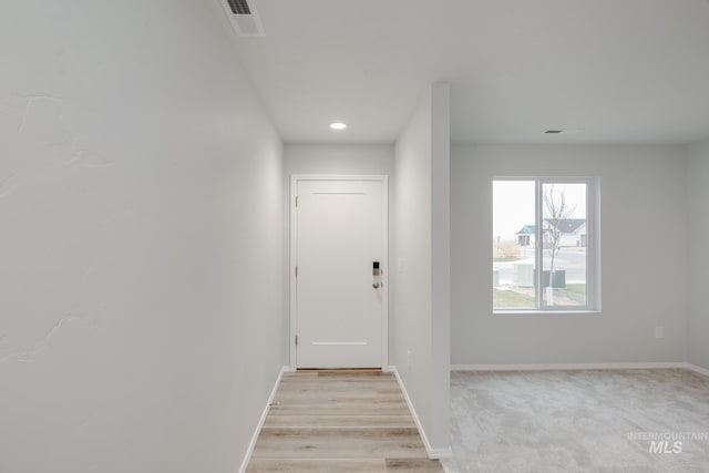 entryway featuring light colored carpet