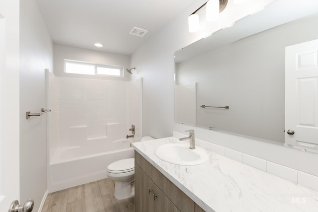 277 N Coltsfoot Ave, Kuna, ID 83634 - bathroom featuring visible vents, toilet, vanity, wood finished floors, and washtub / shower combination