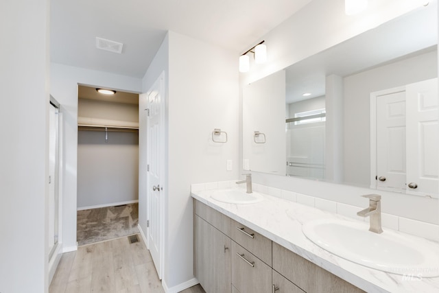 277 N Coltsfoot Ave, Kuna, ID 83634 - full bathroom with a shower stall, double vanity, visible vents, and a sink