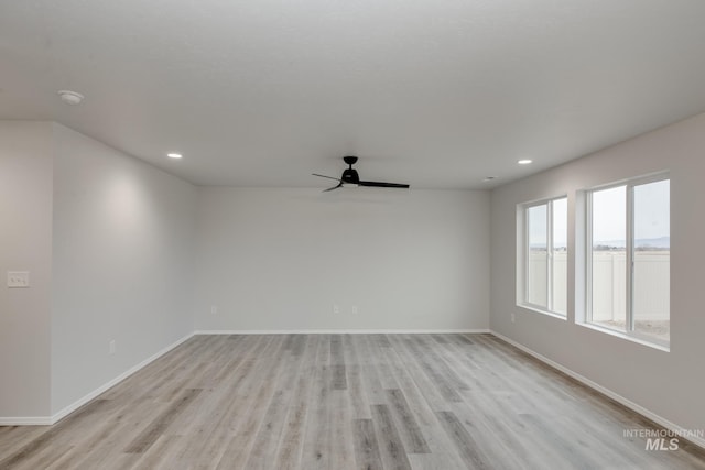 empty room featuring ceiling fan and light hardwood / wood-style flooring