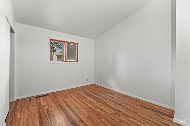 1913 W Suncrest Dr, Boise, ID 83705 - unfurnished room with lofted ceiling, wood finished floors, and baseboards