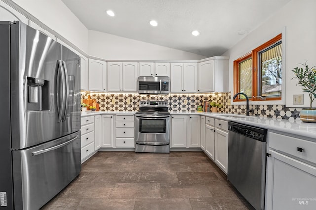 1913 W Suncrest Dr, Boise, ID 83705 - kitchen with appliances with stainless steel finishes, a sink, lofted ceiling, light countertops, and white cabinetry