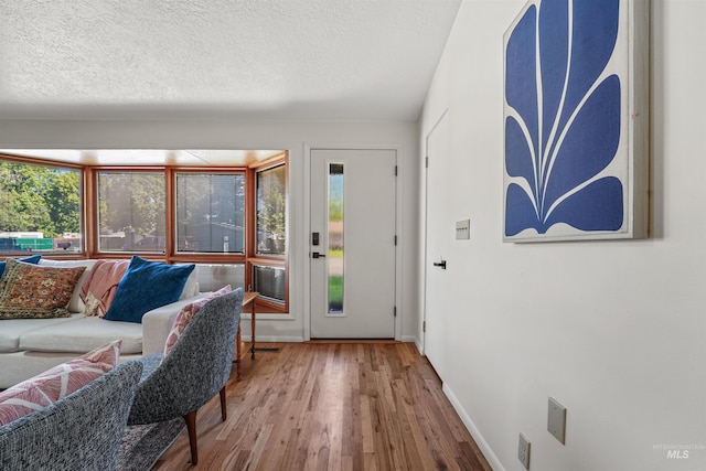 1913 W Suncrest Dr, Boise, ID 83705 - living room featuring wood finished floors, baseboards, and a textured ceiling