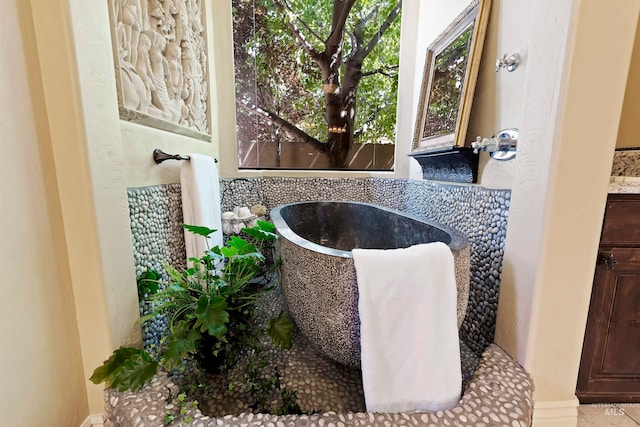 bathroom view of a freestanding bath and vanity