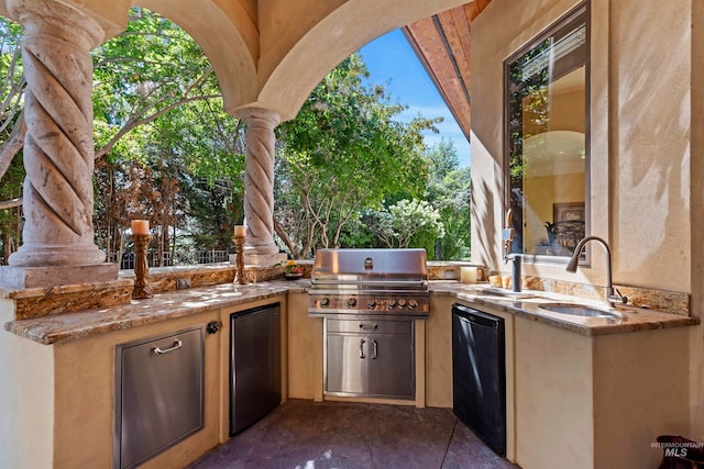 view of patio with a sink, a grill, and exterior kitchen